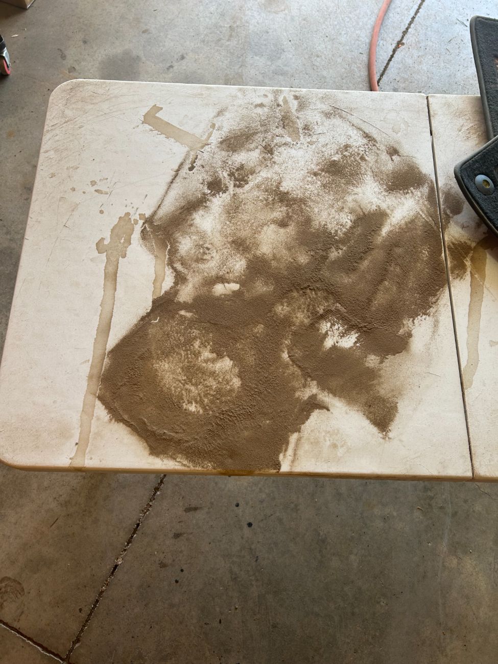Pile of dirt extracted from the carpet, on a table