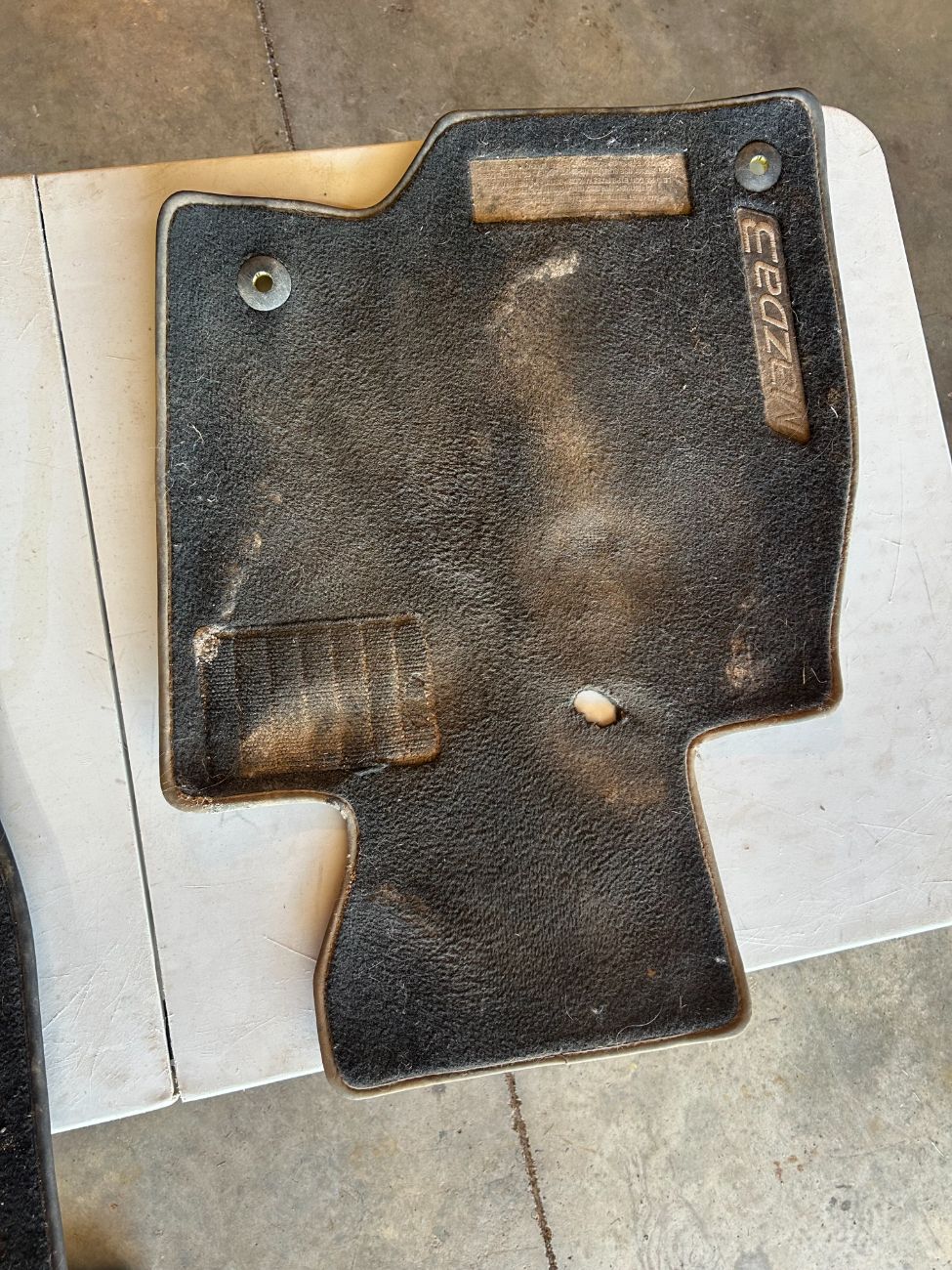 Dirty Mazda3 floor mat before 506 Detailing deep clean